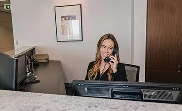 Receptionist helping clients at the front desk